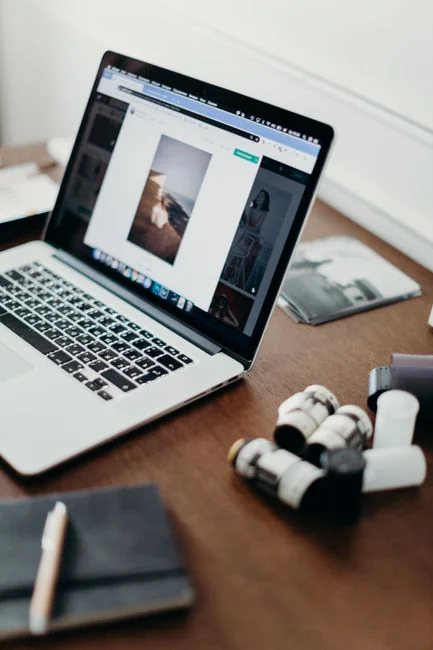 A miniature shopping cart placed on a laptop keyboard symbolizing online shopping and e-commerce.
